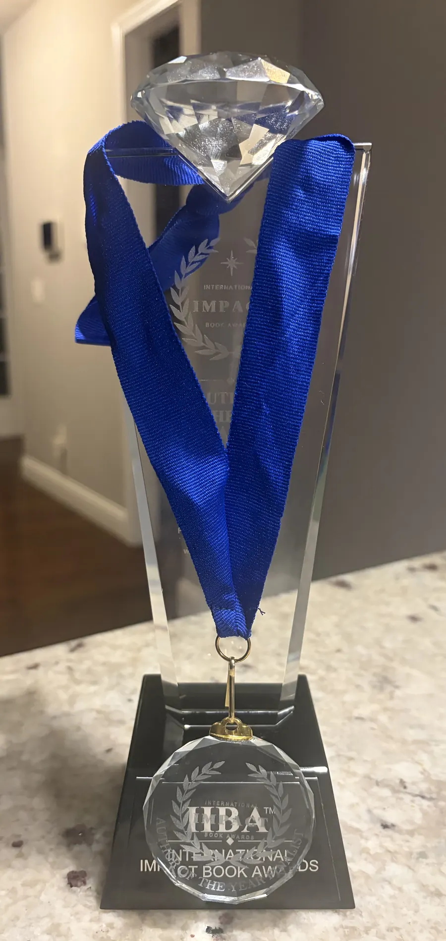 The trophy with the finalist medal and blue ribbon