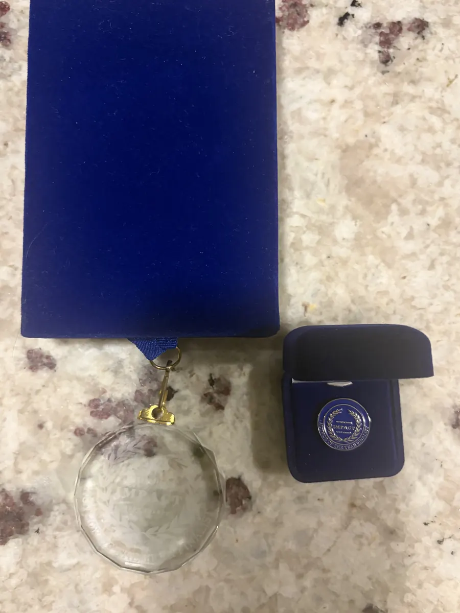 Finalist medal and lapel pin in their presentation boxes